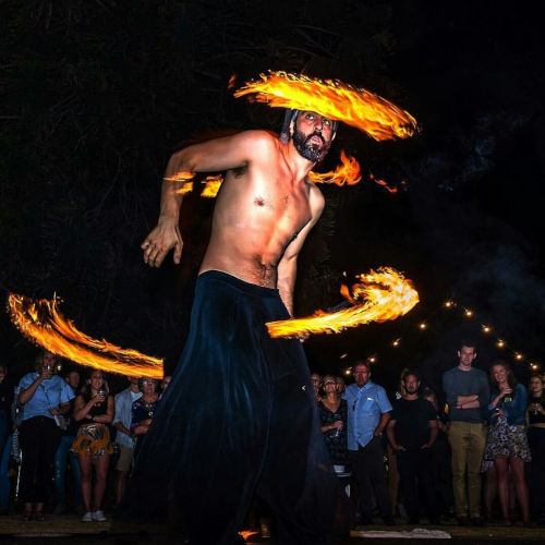 Into the fire: Miguel Rubio, nighttime scene, fire juggling with vibrant colors