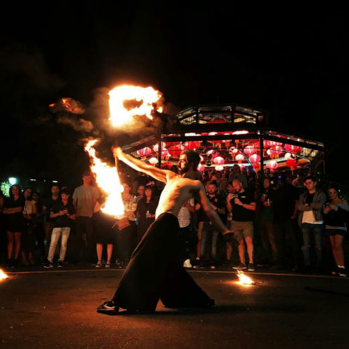 Into the fire: Miguel Rubio, nighttime scene, fire juggling with vibrant colors