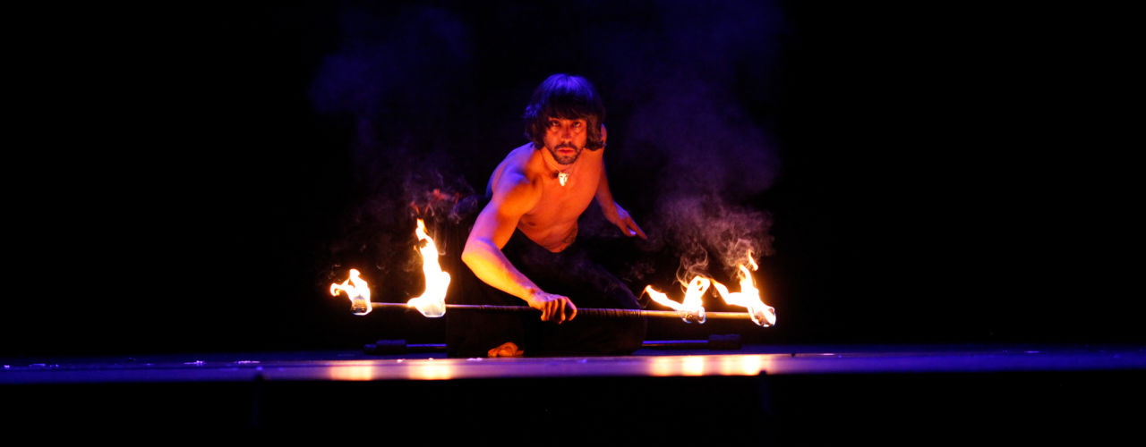 Into the fire: Miguel Rubio, nighttime shot, fire juggling in vivid colors