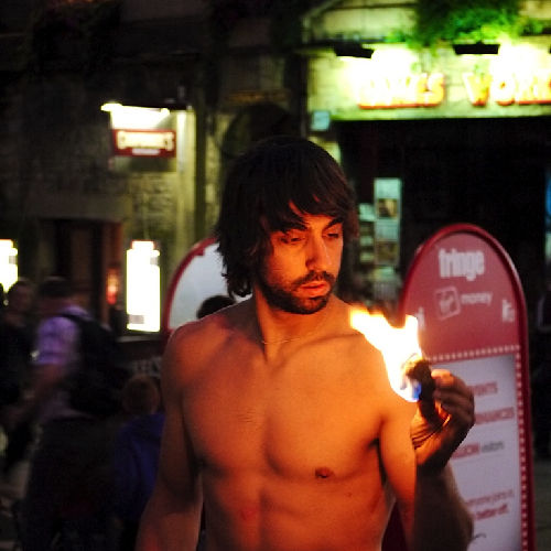 Into the fire: Miguel Rubio, nighttime scene, fire juggling with vibrant colors