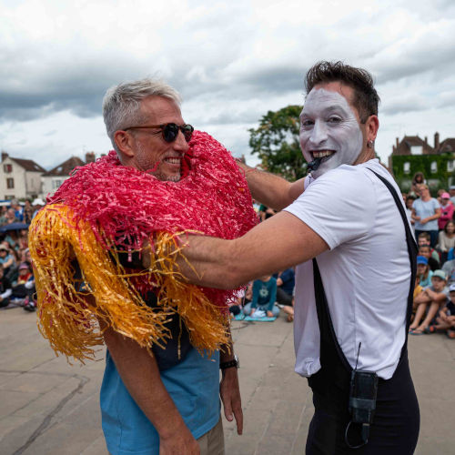 Car Wash mime street performer . Agro the clown putting a car wash roller costume on a spectator.