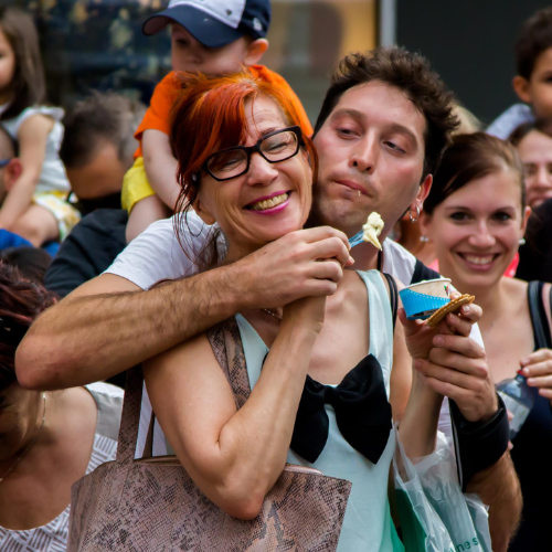 ImproLocura is a clown show. Agro the clown eating ice cream with a smiling spectator.Luca Della Gatta