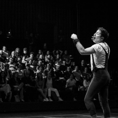 ImproLocura is a comedy show. Agro the clown with the audience in the background. Black and white image. Luca Della Gatta.