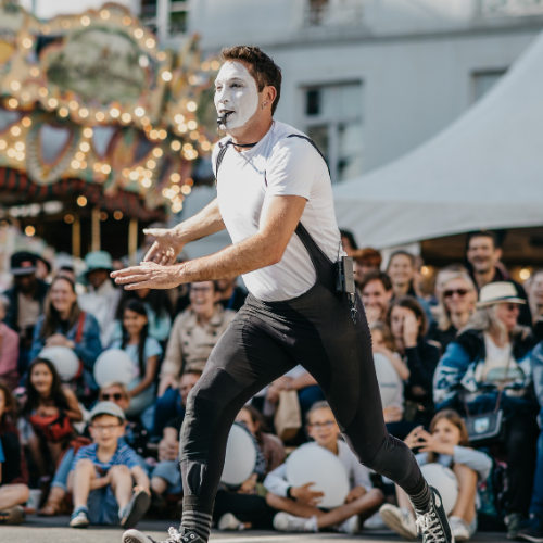 ImproLocura is a clown show. Agro the clown running with the audience in the background. Luca Della Gatta