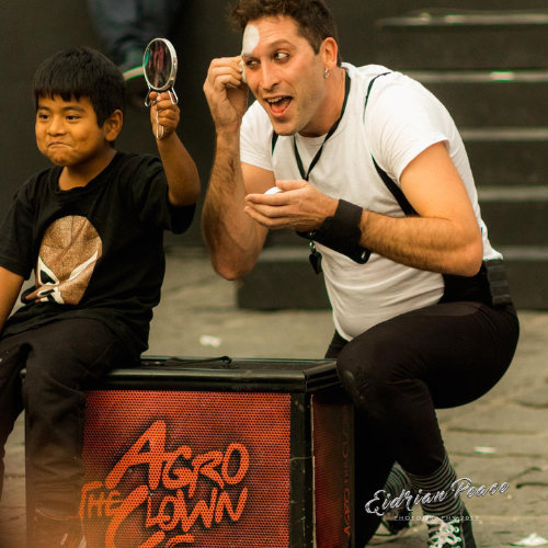 ImproLocura is a physical theater show. Luca Della Gatta. Agro the clown putting on makeup with the help of a child spectator