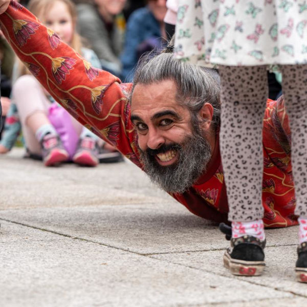 Playground - Chinese Pole Acrobatics Show. Miguel Rubio lying on the ground