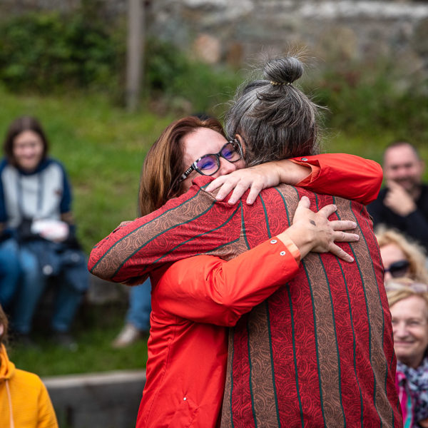 Playground. A chinese pole show with acrobatics, theater, dance, and absurd humor Pole. Miguel Rubio hugging a member of the audience