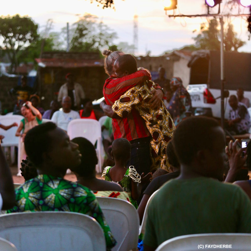 Playground. A chinese pole show with acrobatics, theater, dance, and absurd humor Pole. Miguel Rubio hugging a member of the audience